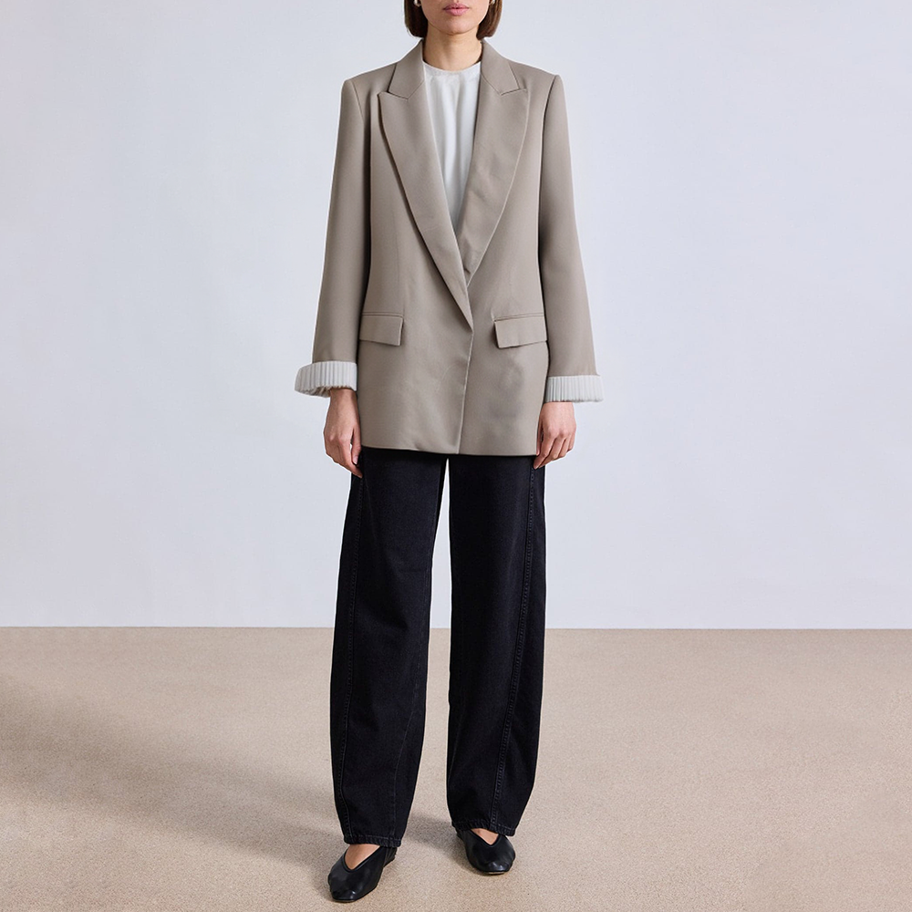 Women's suit jacket with padded shoulders and rolled sleeves